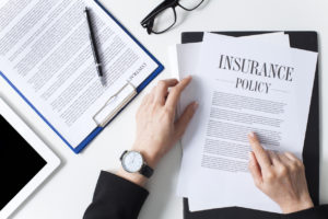 Auto insurance policy document being reviewed after an accident claim